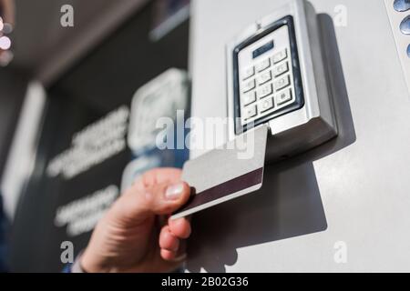 Door access control. Man hand holding key card to lock or unlock door. Stock Photo