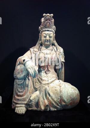 China: Wooden image of Guanyin, the Goddess of Mercy. Ming Dynasty (1368-1644). Guanshiyin or Avalokitesvara is the bodhisattva associated with compassion as venerated by East Asian Buddhists, usually as a female. The name Guanyin is short for Guanshiyin which means 'Observing the Sounds (or Cries) of the World'. It is generally accepted (in the Chinese community) that Guanyin originated as the Sanskrit Avalokitesvara, which is her male form. Commonly known in English as the Goddess of Mercy, Guanyin is also revered in Daoism as an Immortal.In Japan, Guanyin is called Kannon. Stock Photo