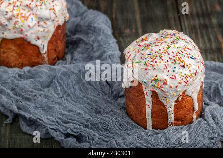 Freshly baked Easter cakes stand on a black wooden table Stock Photo