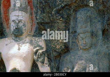 The remote ancient Buddhist site of Bururuvagala (which means ‘stone Buddha images’ in Sinhalese) is thought to date from the 10th century, when Mahayana Buddhism dominated parts of Sri Lanka. Carved into the rock face is a huge 16m-high Buddha figure, with three smaller figures on either side.  Avalokiteśvara ('Lord who looks down') is a bodhisattva who embodies the compassion of all Buddhas. Portrayed in different cultures as either male or female, Avalokiteśvara is one of the more widely revered bodhisattvas in mainstream Mahayana Buddhism, as well as unofficially in Theravada Buddhism. Stock Photo