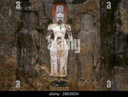 The remote ancient Buddhist site of Bururuvagala (which means ‘stone Buddha images’ in Sinhalese) is thought to date from the 10th century, when Mahayana Buddhism dominated parts of Sri Lanka. Carved into the rock face is a huge 16m-high Buddha figure, with three smaller figures on either side.  Avalokiteśvara ('Lord who looks down') is a bodhisattva who embodies the compassion of all Buddhas. Portrayed in different cultures as either male or female, Avalokiteśvara is one of the more widely revered bodhisattvas in mainstream Mahayana Buddhism, as well as unofficially in Theravada Buddhism. Stock Photo