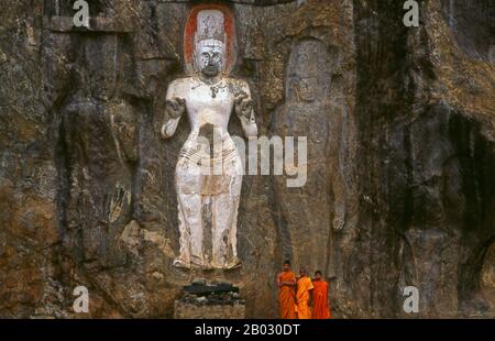 The remote ancient Buddhist site of Bururuvagala (which means ‘stone Buddha images’ in Sinhalese) is thought to date from the 10th century, when Mahayana Buddhism dominated parts of Sri Lanka. Carved into the rock face is a huge 16m-high Buddha figure, with three smaller figures on either side.  Avalokiteśvara ('Lord who looks down') is a bodhisattva who embodies the compassion of all Buddhas. Portrayed in different cultures as either male or female, Avalokiteśvara is one of the more widely revered bodhisattvas in mainstream Mahayana Buddhism, as well as unofficially in Theravada Buddhism. Stock Photo