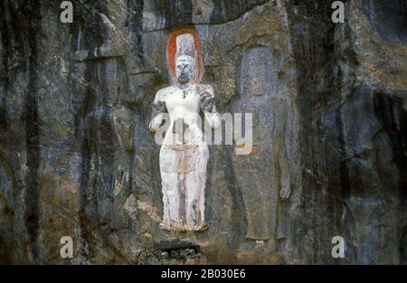 The remote ancient Buddhist site of Bururuvagala (which means ‘stone Buddha images’ in Sinhalese) is thought to date from the 10th century, when Mahayana Buddhism dominated parts of Sri Lanka. Carved into the rock face is a huge 16m-high Buddha figure, with three smaller figures on either side.  Avalokiteśvara ('Lord who looks down') is a bodhisattva who embodies the compassion of all Buddhas. Portrayed in different cultures as either male or female, Avalokiteśvara is one of the more widely revered bodhisattvas in mainstream Mahayana Buddhism, as well as unofficially in Theravada Buddhism. Stock Photo