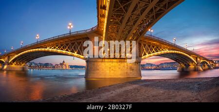 Budapest, Hungary. Panoramic cityscape image of Budapest with Margaret Bridge and Hungarian Parliament Building during beautiful sunset. Stock Photo