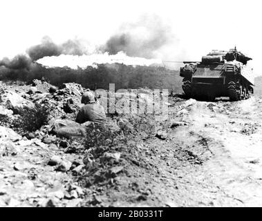 The invasion of Iwo Jima began on February 19, 1945, and continued to March 27, 1945. The battle was a major initiative of the Pacific Campaign of World War II. The Marine invasion was charged with the mission of capturing the airfields on the island, which up until that time had harried U.S. bombing missions to Tokyo. Once the bases were secured, they could then be of use in the impending invasion of the Japanese mainland.  The battle was marked by some of the fiercest fighting of the War. The Imperial Japanese Army positions on the island were heavily fortified, with vast bunkers, hidden art Stock Photo