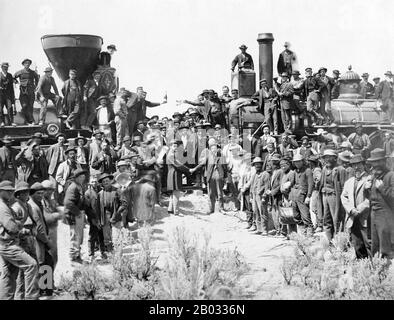The First Transcontinental Railroad (known originally as the 'Pacific Railroad' and later as the 'Overland Route') was a 1,907-mile (3,069 km) contiguous railroad line constructed in the United States between 1863 and 1869 west of the Mississippi and Missouri Rivers to connect the Pacific coast at San Francisco Bay with the existing eastern U.S. rail network at Council Bluffs, Iowa.  Opened for through traffic on May 10, 1869 with the ceremonial driving of the 'Last Spike' at Promontory Summit, the road established a mechanized transcontinental transportation network that revolutionized the se Stock Photo