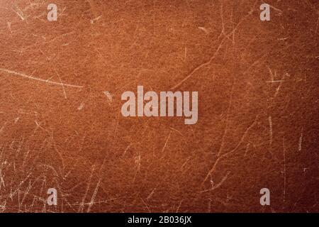 Scratched brown leather texture, background. Worn old skin, abstract pattern. Grunge surface of material, natural vintage belt with scuffs Stock Photo