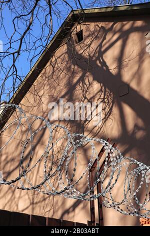 Razor wire fence over wall protects middle-class residential ...