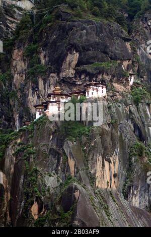 Paro Taktsang, also known by the names Taktsang Palphug Monastery and the Tiger's Nest, is a major Buddhist sacred site and temple complex built into the 1,000-metre (3,281-foot) cliffside of the upper Paro valley in Bhutan. Stock Photo