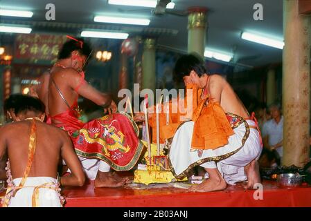 Thailand: A possessed spirit medium or ma song, The Nine Emperor Gods Festival, Chao Mae Thapthim Shrine (Taoist Chinese joss house), Wang Burapha, Bangkok (1989). The Nine Emperor Gods Festival is a nine-day Taoist celebration beginning on the eve of 9th lunar month of the Chinese calendar, which is observed primarily in Southeast Asian countries like Myanmar, Singapore, Malaysia, and Thailand. Stock Photo