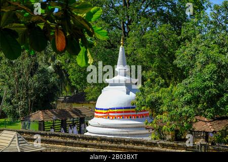 Kandy, Sri Lanka - January 2020: People praying at the Natha Devale Buddhist Temple on January 26, 2020 in Kandy, Sri Lanka. Stock Photo