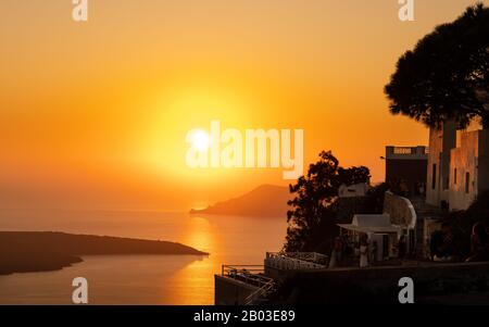 A view of the sun going down from the caldera at the village of Oia on the island of Santorini in Greece. Stock Photo