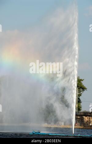 Hamburg’s landmark of the 35m high Alsterfontane (Alster fountain) producing the colours of a rainbow in the Binnenalster or the Aussen-Alster (Alster Stock Photo