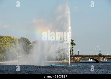 Hamburg’s landmark of the 35m high Alsterfontane (Alster fountain) producing the colours of a rainbow in the Binnenalster or the Aussen-Alster (Alster Stock Photo