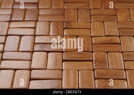 The mat is made of rectangular, sanded and varnished bamboo wood blocks. Background. Stock Photo