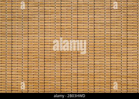 A woven Mat of reeds or straw-yellow in color. The texture of dry cane. Light yellow Stock Photo