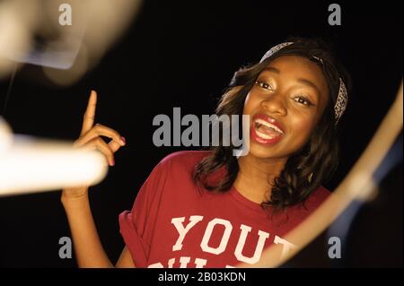 British female rapper Little Simz (real name Simbiatu Abisola Abiola Ajikawo) performing at the piano during the video shoot for Leave It As That. Stock Photo