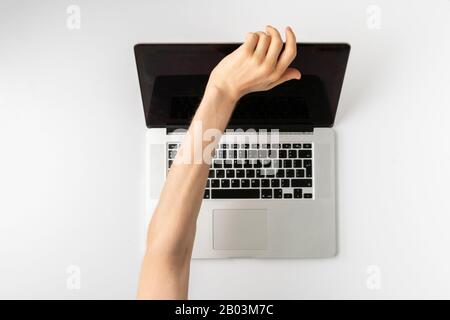 a top view of person hands close cover or block the laptop webcam, being afraid of spy hack the camera Stock Photo