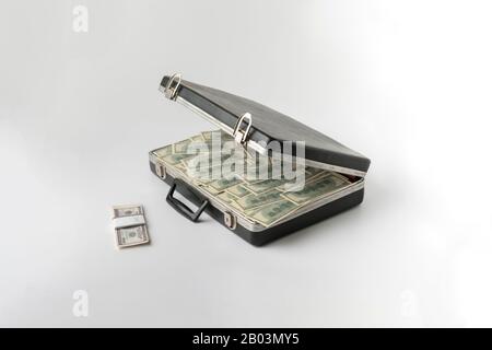 opened vintage case full of cash dollar money, hundred banknote on color surface Stock Photo