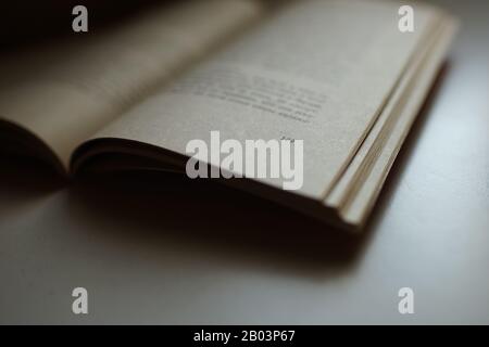 Open book on the table. Side view. Stock Photo