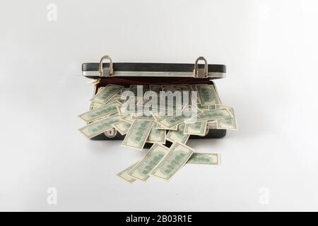 opened vintage case full of cash dollar money, hundred banknote on color surface Stock Photo