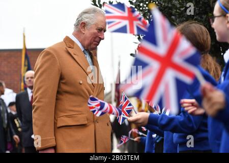 The Prince of Wales speaks to school children during a visit to the Veterans Contact Point, a charity that was created, supports and is run by veterans, in Nuneaton during a tour of Warwickshire and the West Midlands. Stock Photo