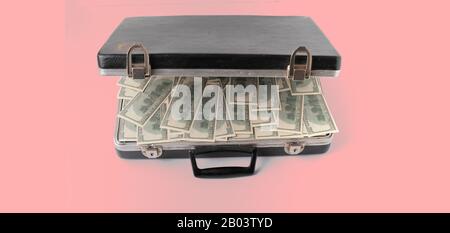 opened vintage case full of cash dollar money, hundred banknote on color surface Stock Photo