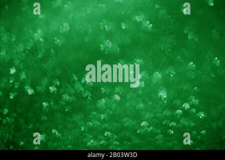 Clover shaped bokeh. St.Patrick 's Day. Blurred abstract background. Green shamrock Stock Photo