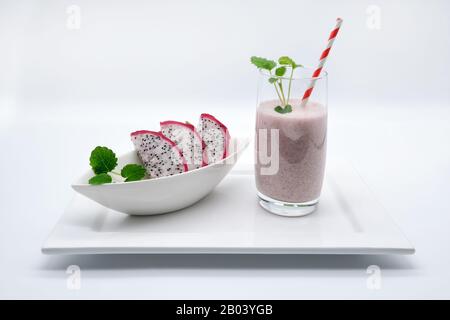 a dragon fruit / kite fruit smoothie on a white porcelain plate with white background, advertising space Stock Photo