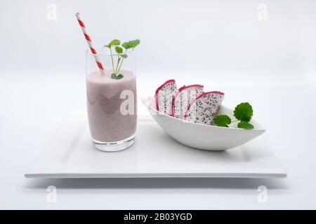 a dragon fruit / kite fruit smoothie on a white porcelain plate with white background, advertising space Stock Photo