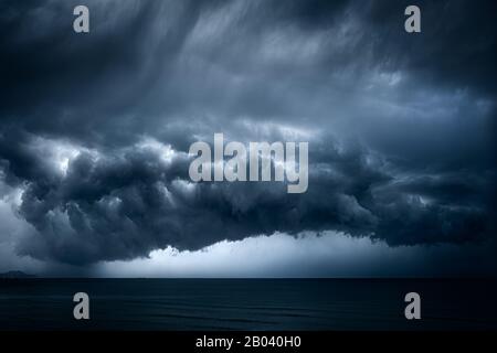 dark and dramatic stormy clouds over sea Stock Photo