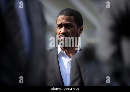 Washington, USA. 18th Feb, 2020. Pastor Darrell Scott listens to Former NFL football players after a meeting with President Donald Trump after he signed an executive order granting a full pardon to Edward DeBartolo Jr., the former San Francisco 49ers owner convicted in a gambling fraud scandal. (Photo by Oliver Contreras/SIPA USA) Credit: Sipa USA/Alamy Live News Stock Photo