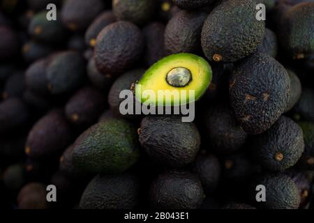 Ripe, black-purplish Hass avocados are seen offered for sale in the street of Medellín, Antioquia department, Colombia. Stock Photo
