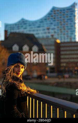 Young middle east girl model durning a sunset in the port of Hamburg. Stock Photo
