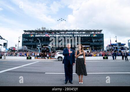 U.S President Donald Trump and First Lady Melania Trump, stand for the national anthem at Daytona International Speedway February 16, 2020 in Daytona Beach, Florida. Trump served as the official starter of the the NASCAR Daytona 500 auto race and took a ride in the presidential limousine around the track. Stock Photo