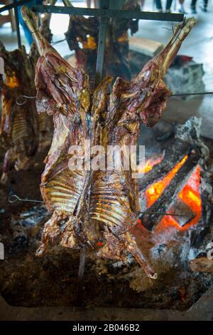 Asado (traditional lamb barbecue) in Puerto Chacabuco in the Chilean Fjords in southern Chile. Stock Photo