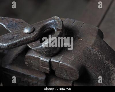 Old metal wire cutters lie on a rusty vise. The concept of working tools Stock Photo