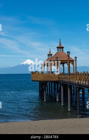 Pier in Frutillar, a small town on Lake Llanquihue in the Lake District near Puerto Montt, Chile with Osorno Volcano in background. Stock Photo