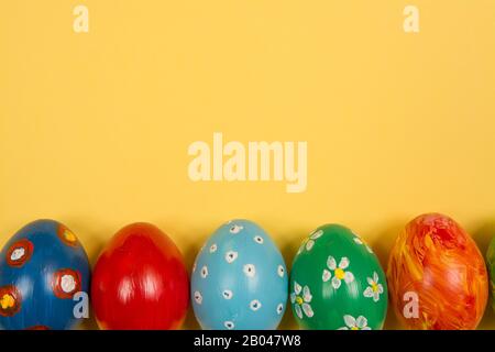 Easter holiday background. Coloured decorated easter eggs on a bright ...