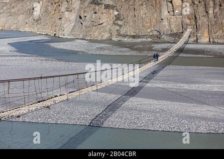 Hussaini suspension bridge passu cones mountain range rocky scenery huzza river gilt baltistan northern areas Pakistan Stock Photo