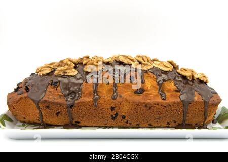 Sponge cake with walnuts against a white background Stock Photo