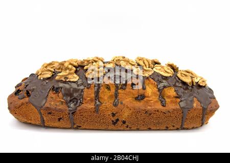 Sponge cake with walnuts against a white background Stock Photo