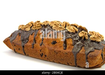 Sponge cake with walnuts against a white background Stock Photo