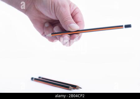 Male hand holding a brand new pencil Stock Photo