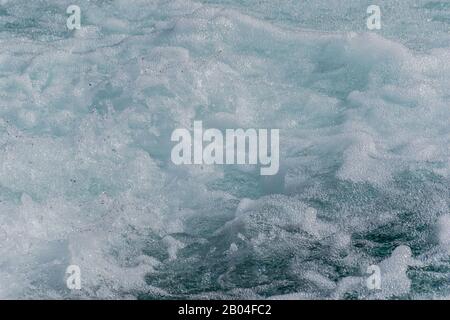 White wave foam of a strong current mountain river close-up shot (background or backdrop) Stock Photo