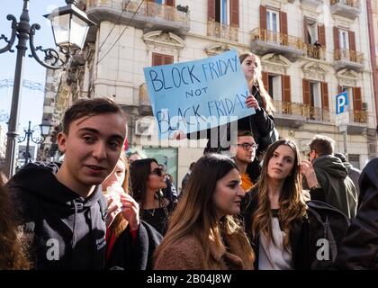 Girl on the back of a companion shows a sign protesting against climate change. Stock Photo