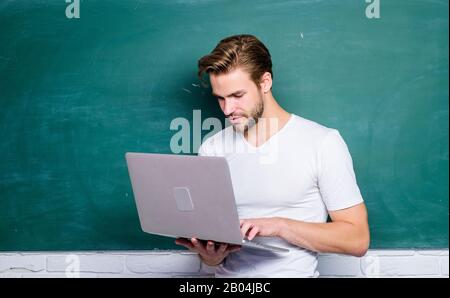 Programming web development. Digital concept. Student learn digital world. Surfing internet. Online communications. School teacher with laptop. Handsome man use modern technology. Digital technology. Stock Photo