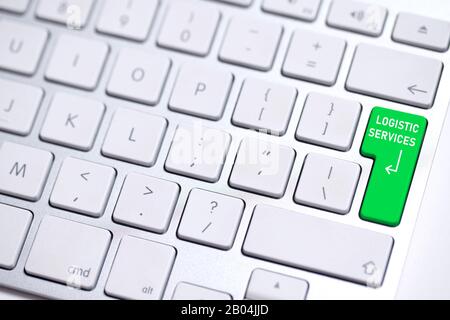metal keyboard with colored enter key and the word "logistic services" on it Stock Photo