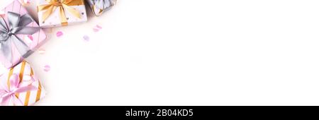 Several gift boxes with bows and confetti on a white background. Stock Photo
