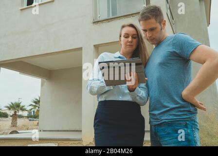 Real estate agent shows the development to his client. Stock Photo